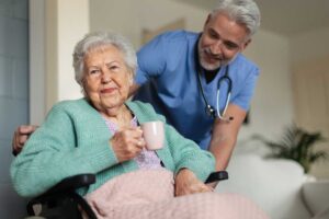 Older adult and family member reviewing a medication organizer at a kitchen table