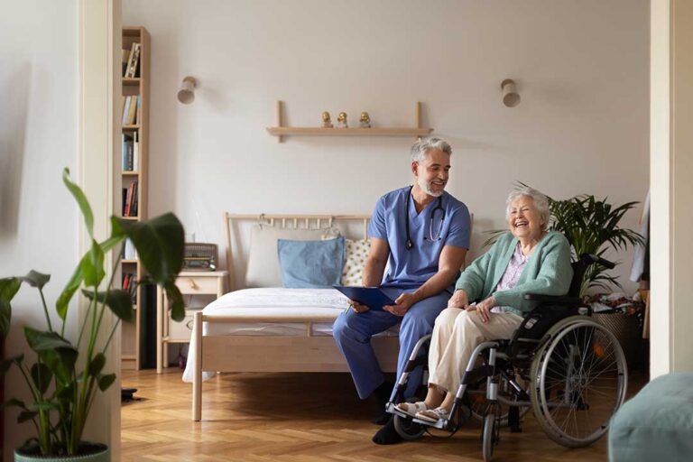 Older adult and family member reviewing a daily care checklist at a kitchen table